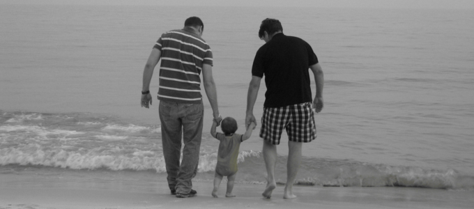 Image - two parents with baby on beach